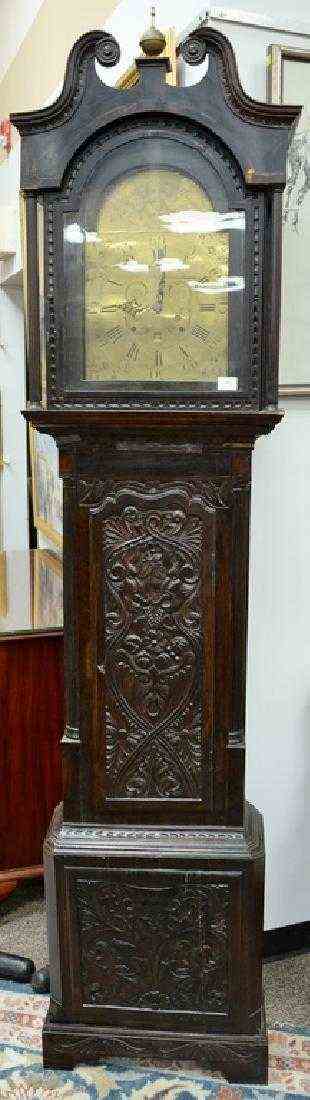 English oak tall clock with carved door and base,